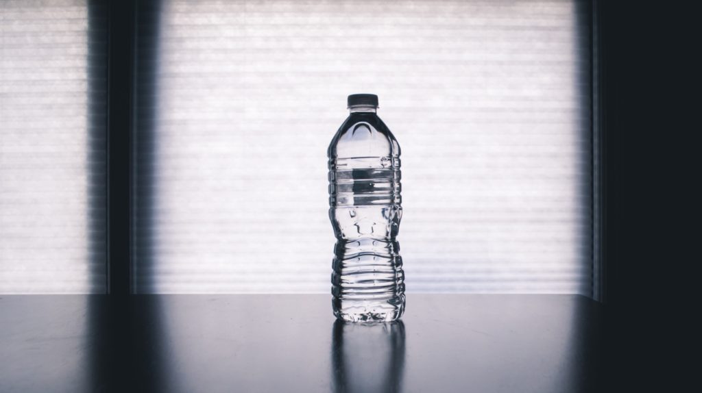 clear disposable bottle on black surface 1000084