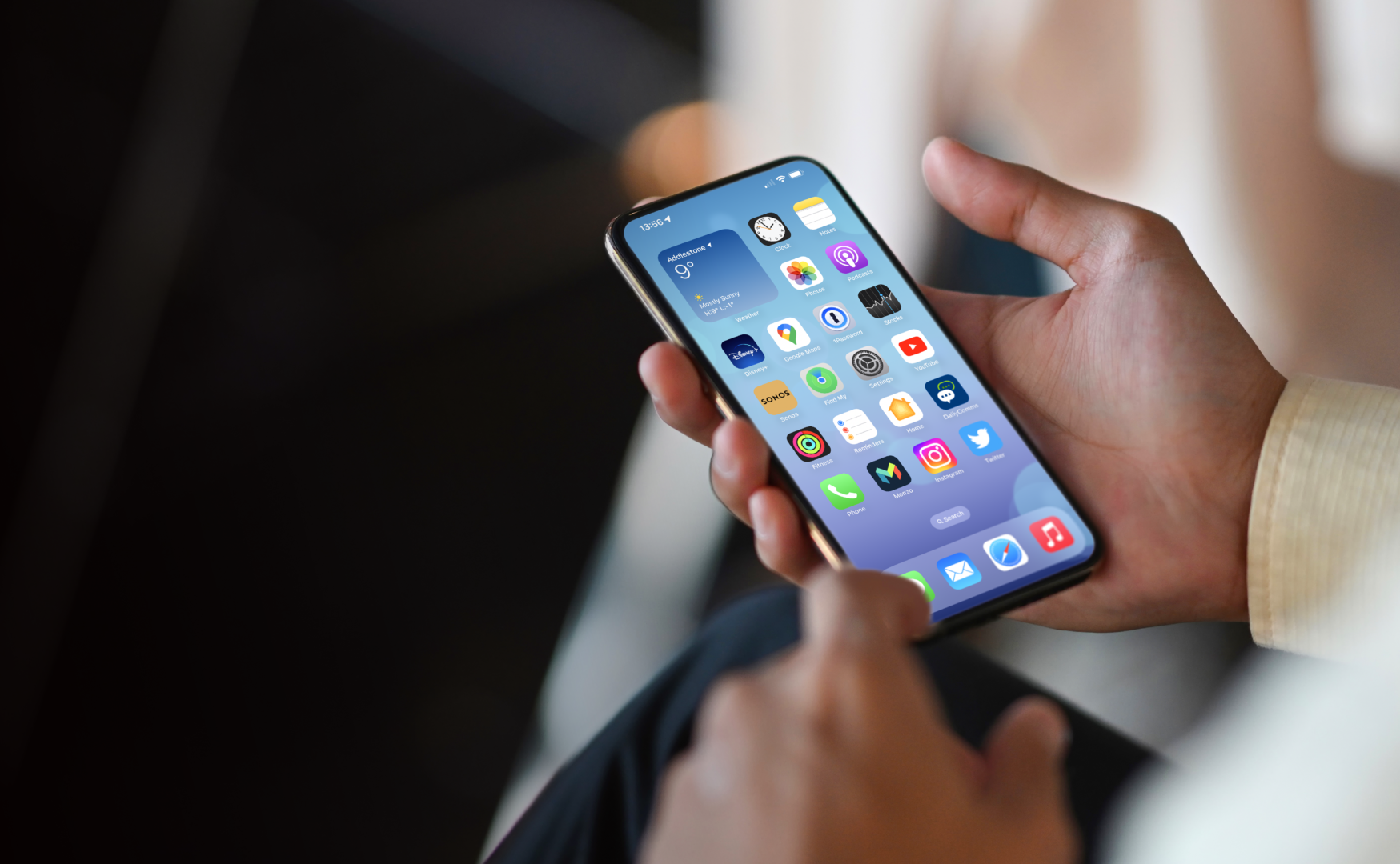 Someone holding iPhone in hand with Philips app on the homescreen
