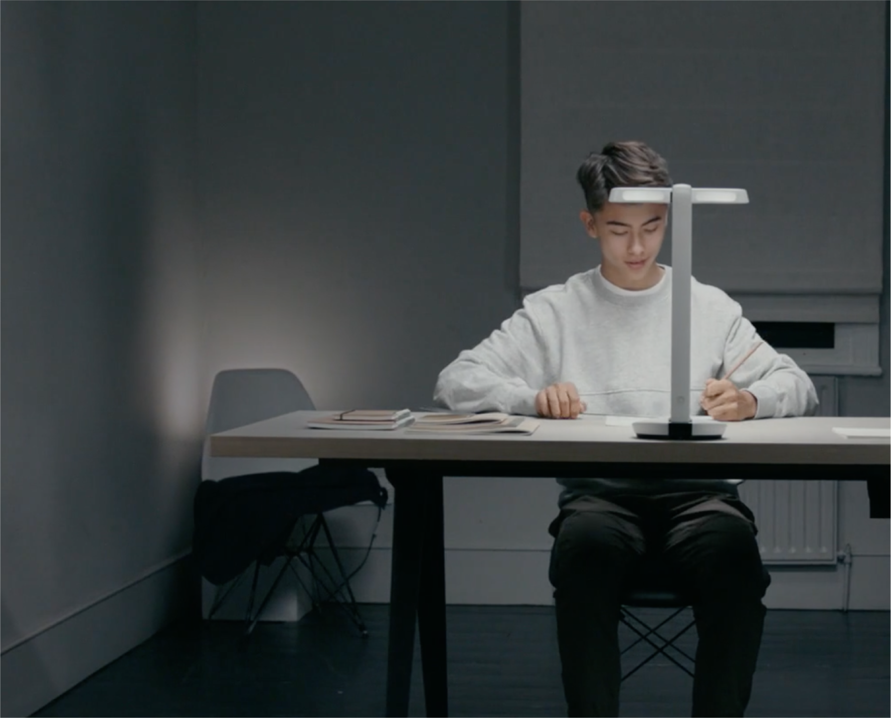 OcuMax image of young man wokring using a desk lamp