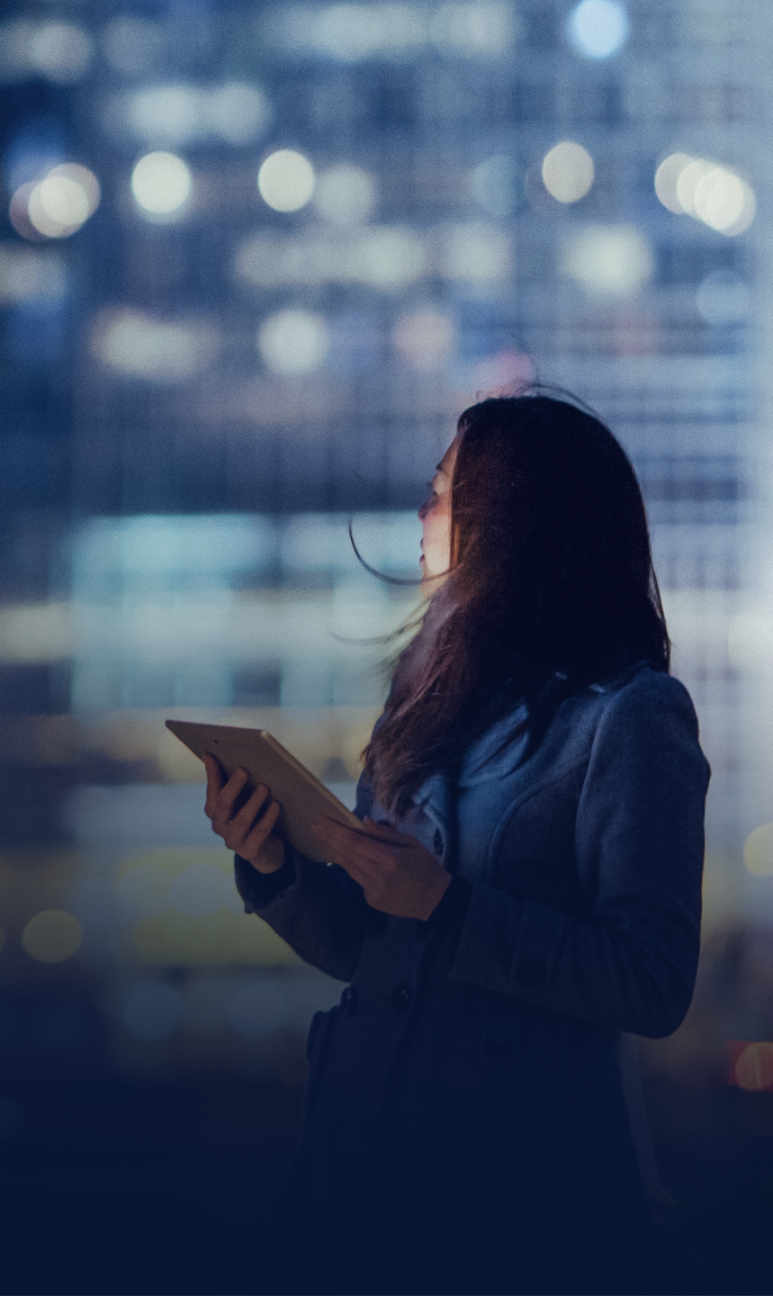 Woman on tablet with city backdrop