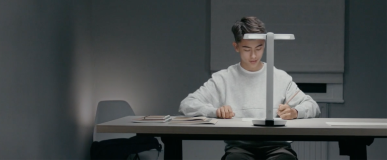 OcuMax image of young man wokring using a desk lamp